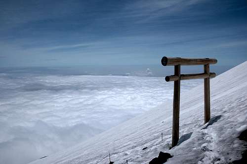 Torii on snow above the clouds