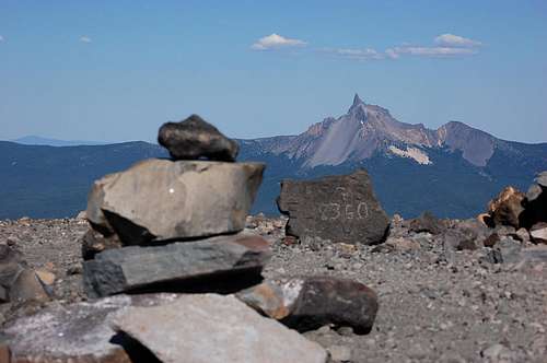 Summit cairn and elevation marker on Mt. Bailey with Mt. Thielsen in the distance