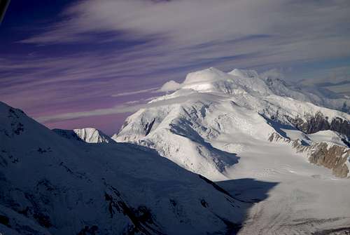 The Bulk of Mount McKinley (Denali) looming above the surrounging glaciers in early morning light in the Alaska Range.