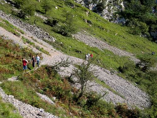 Hikers crossing one of the srcees