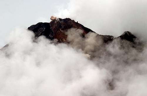 Arenal emits a small cloud of ash
