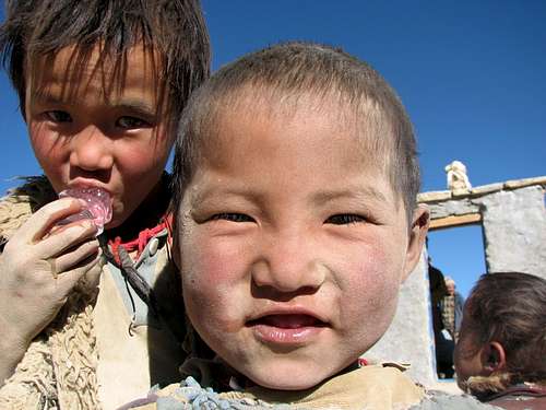 Tibetan children savouring ice...