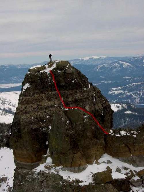 A lone climber stands atop...