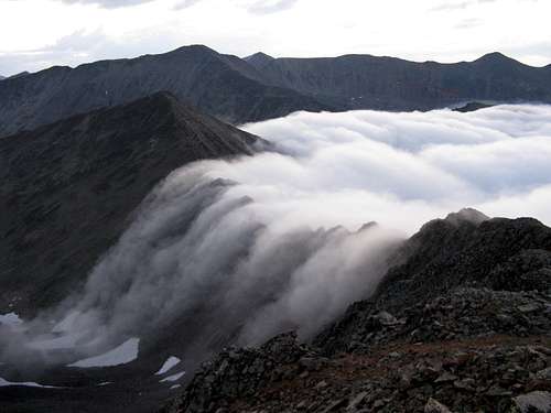 Clouds spilling over ridge