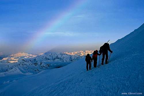 Climbing Elbrus vith Rainbow light background...