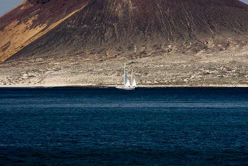 Sailing boat in front of Montaña Amarilla