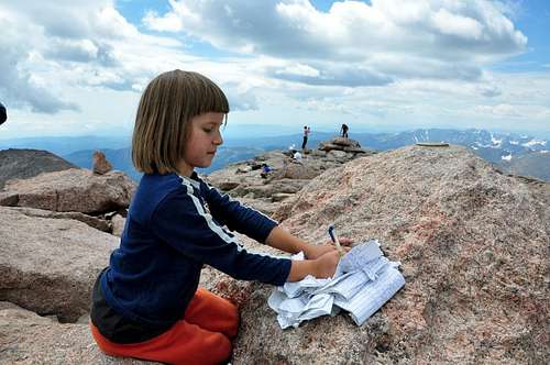 Yunona is sighning log book at Long's Peak 14256 ft 6 years 1 month of age 