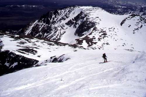 A skier descends toward the...