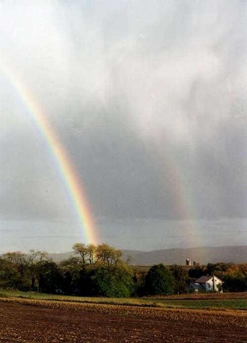 Two rainbows touch the valley...