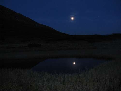 Full moon reflecting in a tarn