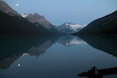 Glacier lake at dawn, with the moon still in the sky