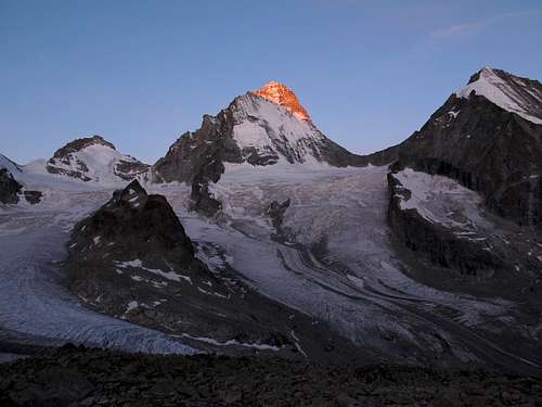 The first rays of sunlight hit the top of Dent Blanche