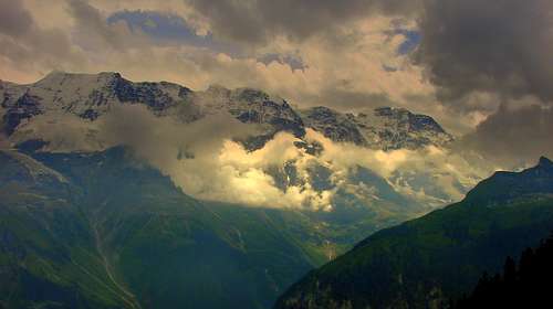 Ebenefluh, Mittaghorn and Grosshorn with clouds and sunbeams that  illuminate them
