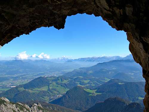 Looking through a natural rock window over the Salzach valley to Dachstein and Tennengebirge 