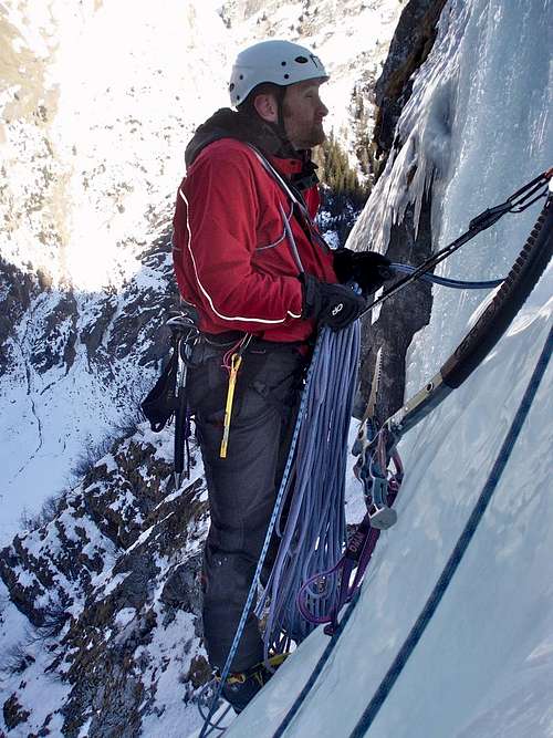 Ice climbing - Chris at the hanging belay on Cascade de Bonatchiesse
