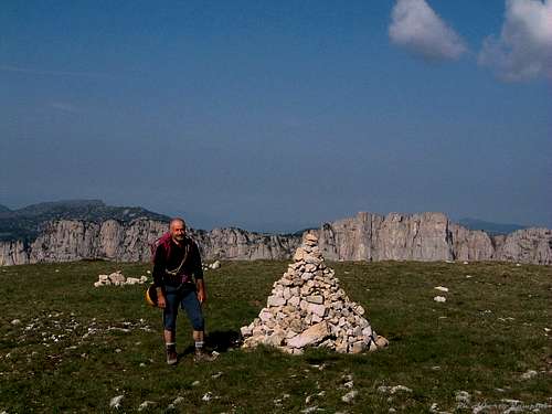A lonely cairn over the wide summit of Mont Aiguille, Vercors 