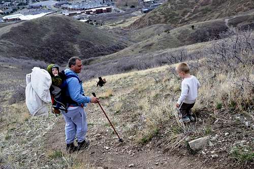 Two men in focus: 3 year old boy descending Mt. Wire on the slope