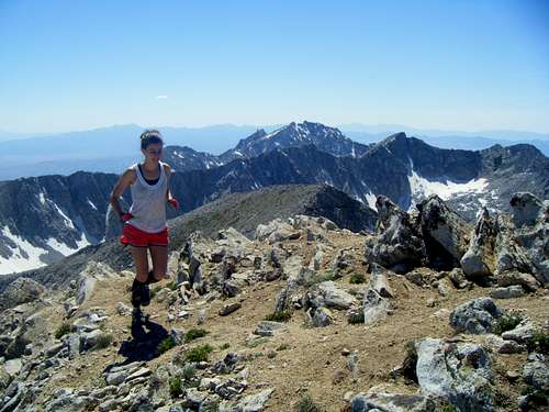 Brit running on the Summit with Lone Peak and the rest of the Alpine Ridgeline in the distance
