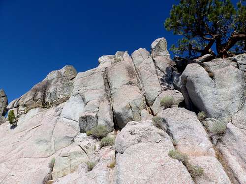 View up the rock towers that make up the summit of Peak 8205