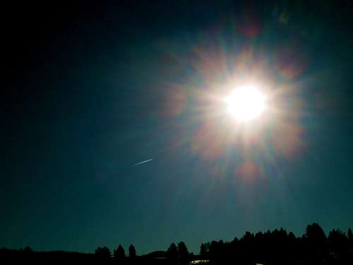 Plane flying into the sun, Blacktail Plateau, Yellowstone National Park