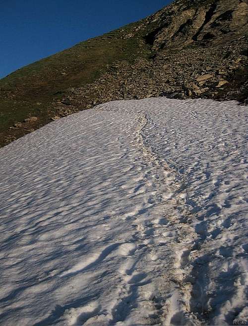 It's early summer, and the trail to Naafkopf crosses an old snowfield