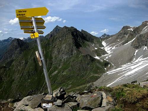 Crooked sign post at Gahwinden, with view NNE to Kapuzinerjoch (Rötkarjoch), with Felderkogel (3071m) sticking out above