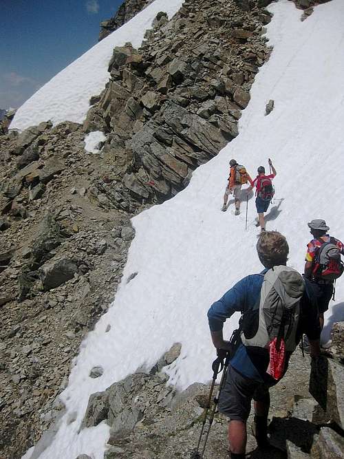 Carefully crossing a steep snowfield on the Hohe Geige normal route