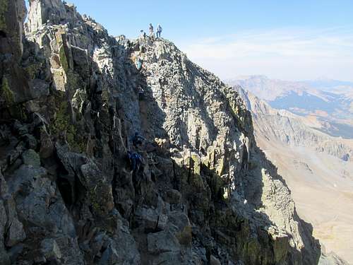 line of climbers negotiating downclimb