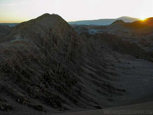 People over a hill on Valle De La Luna