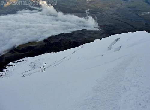 A couple climbers negotiating a huge crevasse on Cotopaxi