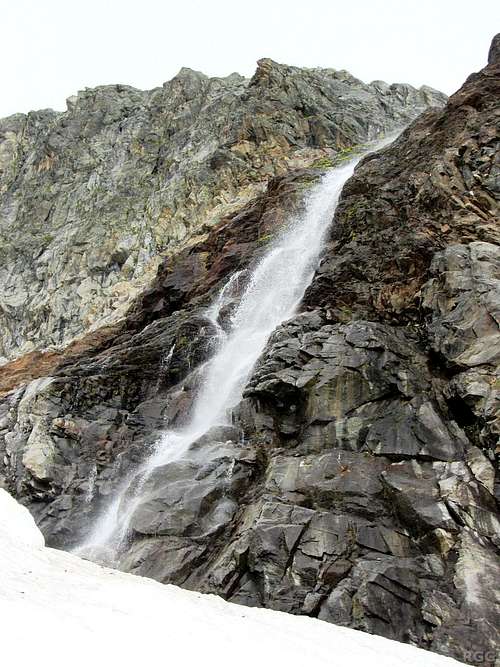A waterfall tumbling down the flanks of the Silvrettahorn on the Ochsental Glacier