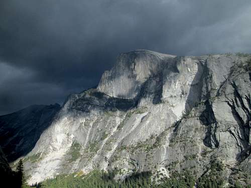Half Dome seen from partway up the South Face of the Washington Column, with storm clouds approaching