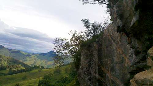 Climber on exposed cliffs of Corujas sector