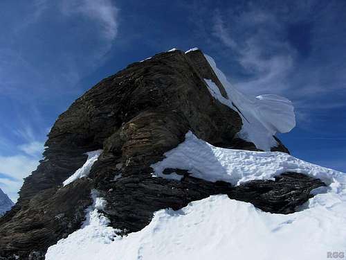 A dangerously overhanging cornice clinging precariously to the summit of Mont de l'Etoile