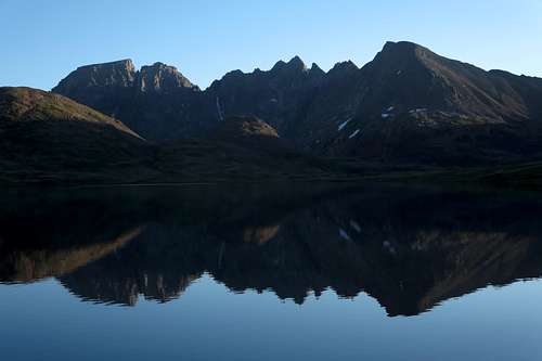 Wolf Mountain, Sawtooth Peaks, and Sawtooth Mountain Reflected on Goose Lake, Dawn