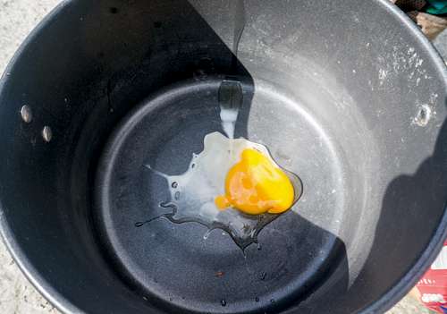 Frying a wild bird egg at our glacial lake.