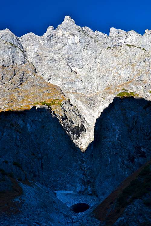 The south east face of Kleiner Watzmann and a snow cave at it's foot