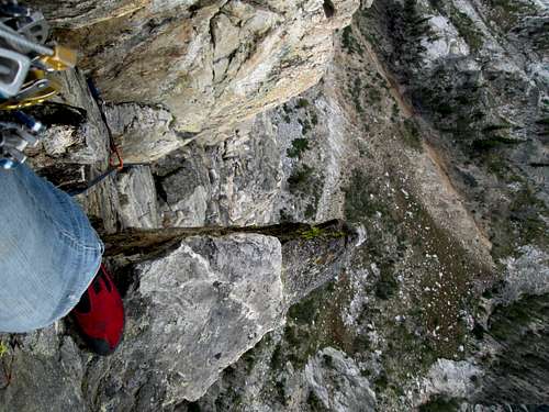 Looking down from near the top of the Southwest Ridge of Symmetry Spire on a pie piece shaped ledge, Teton Range, WY