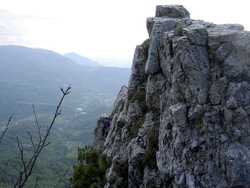 A climber reaching the summit of I Apostolo