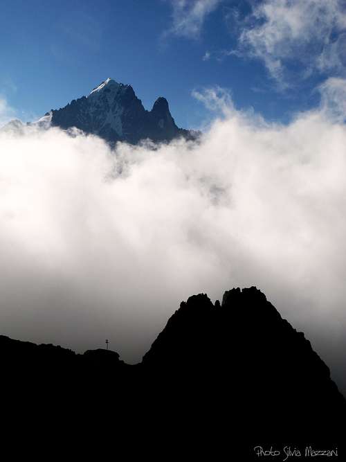 Petit Dru and Aiguille Verte stand out the clouds