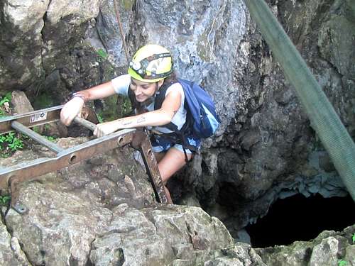 My guide Lucile going down the ladder into the cave