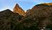 The silhouette of Pierre André emerges behind the first rocky buttress