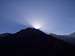 Sun disappears behind mountain